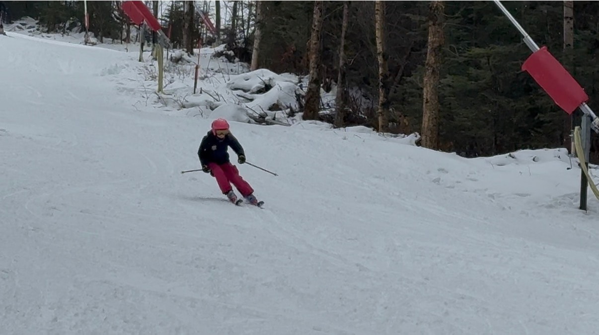 Teenage ski racer on downhill course